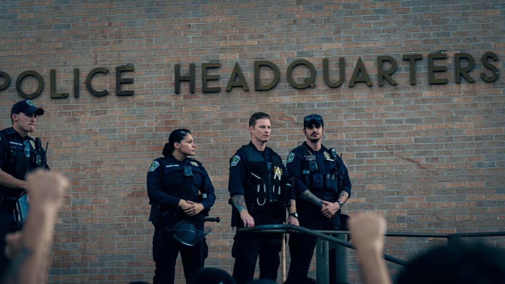 Police in front of a Police Headquarters precinct.