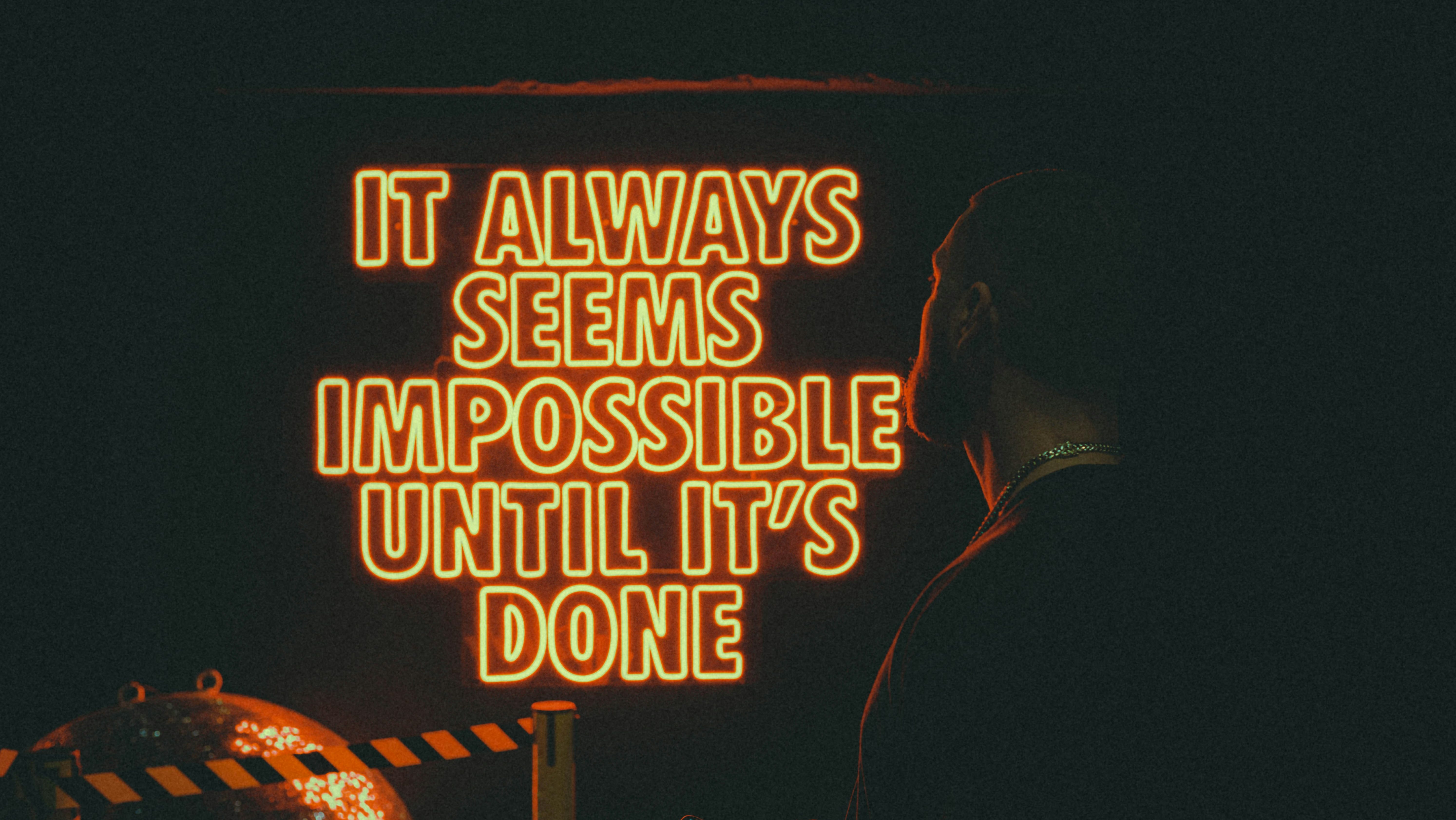 Image of a neon sign saying "It Always Seems Impossible Until it's Done".